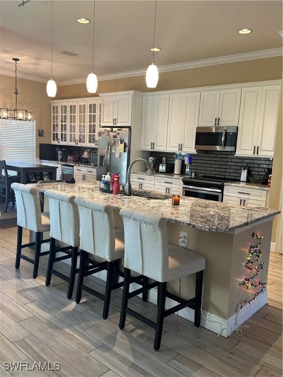 kitchen featuring pendant lighting, a spacious island, and appliances with stainless steel finishes