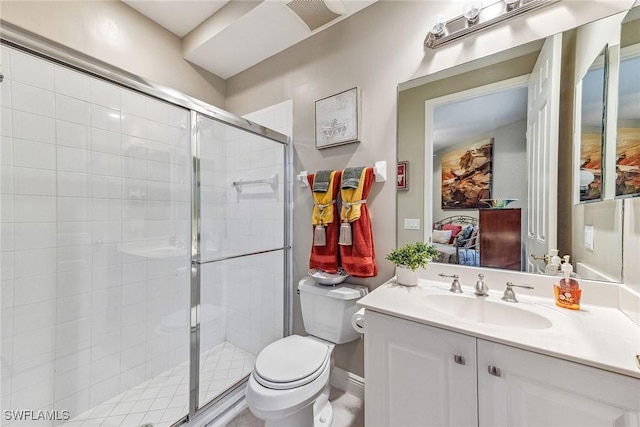 bathroom with toilet, vanity, and walk in shower