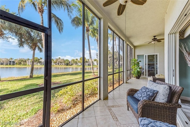 sunroom with plenty of natural light and a water view