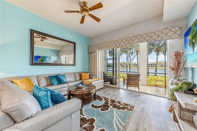 9275 Museo Cir Unit 103, Naples, FL 34114 - living room with wood finished floors, a water view, and ceiling fan
