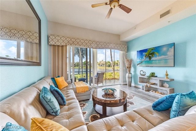 living room featuring ceiling fan and hardwood / wood-style floors