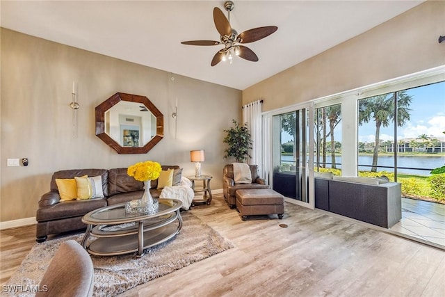 9275 Museo Cir Unit 103, Naples, FL 34114 - living room with a water view, baseboards, wood finished floors, and ceiling fan