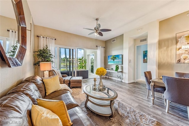 living room with ceiling fan and light wood-type flooring