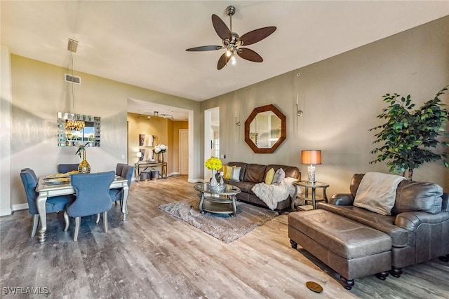 living room featuring ceiling fan and hardwood / wood-style flooring