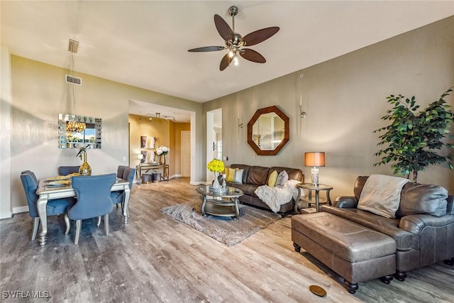 9275 Museo Cir Unit 103, Naples, FL 34114 - living area with baseboards, visible vents, wood finished floors, and ceiling fan