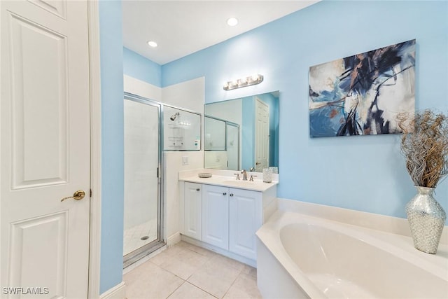 bathroom with shower with separate bathtub, tile patterned floors, and vanity