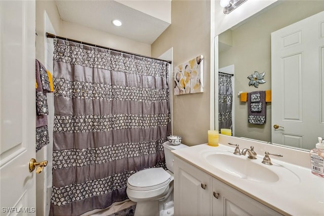 bathroom with a shower with curtain, vanity, and toilet