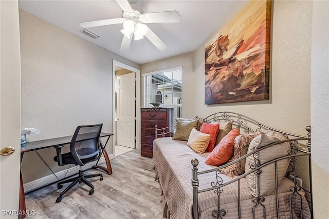 office space with light wood-type flooring and ceiling fan