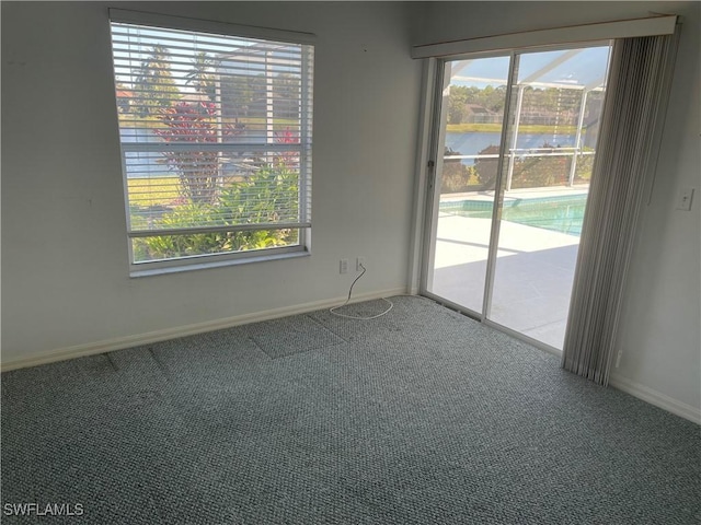 empty room with carpet and a water view