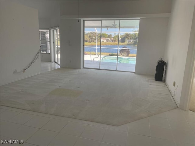 unfurnished room with ceiling fan and light tile patterned floors