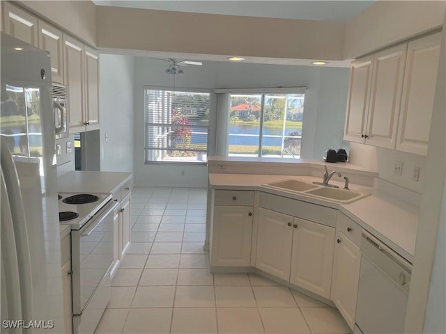 kitchen with sink, white appliances, white cabinetry, and light tile patterned flooring