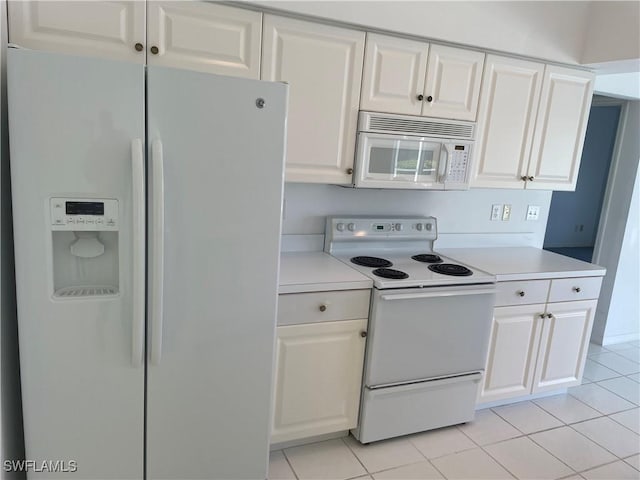 kitchen featuring white cabinetry, white appliances, and light tile patterned floors