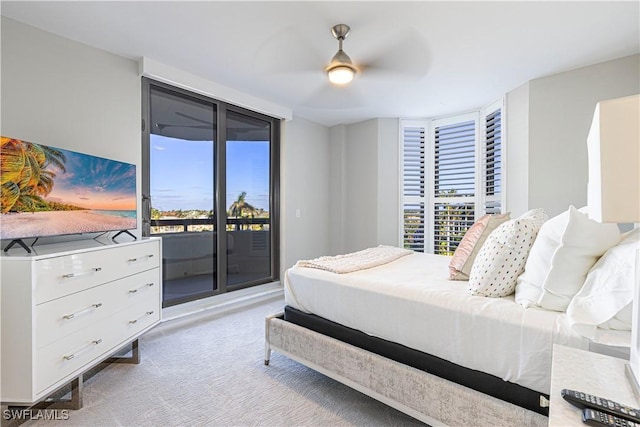 bedroom featuring ceiling fan, access to outside, multiple windows, and light colored carpet