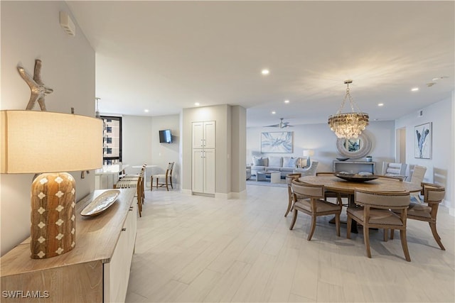 dining area featuring light wood-type flooring, baseboards, a chandelier, and recessed lighting