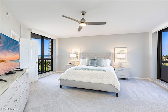 carpeted bedroom featuring ceiling fan, floor to ceiling windows, and access to exterior