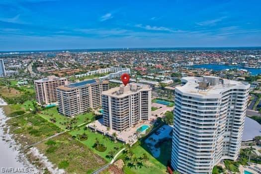 birds eye view of property with a city view and a water view