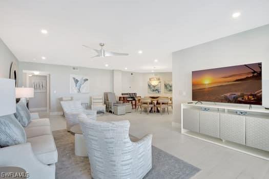 living area featuring a ceiling fan and recessed lighting