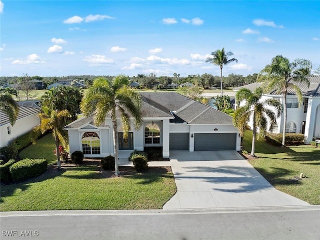 view of front of property featuring a front yard and a garage