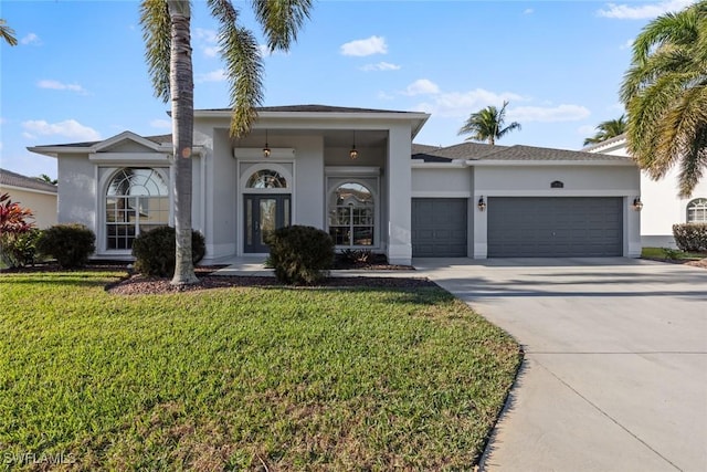 view of front of house featuring a front yard and a garage