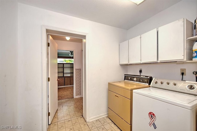 laundry room featuring cabinets and washer and dryer