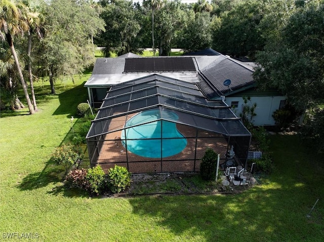 view of swimming pool featuring a yard and a lanai