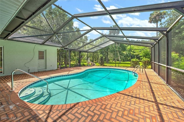 view of pool with a patio and glass enclosure