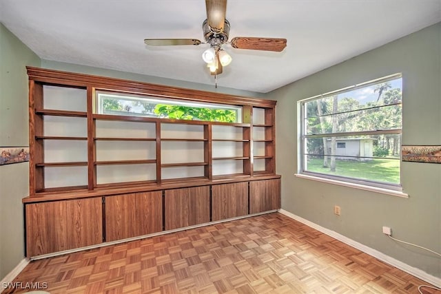 empty room featuring ceiling fan and light parquet flooring