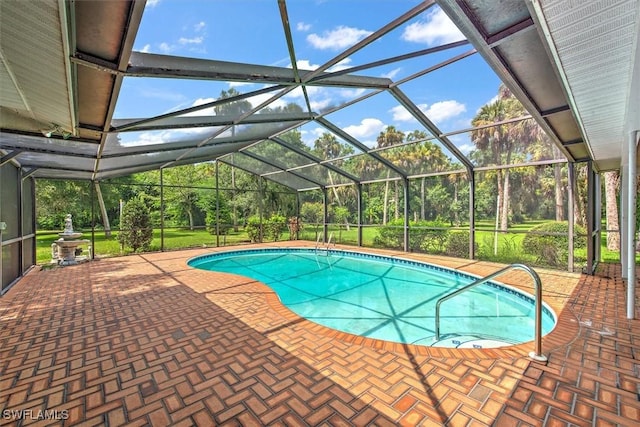 view of swimming pool featuring glass enclosure and a patio area