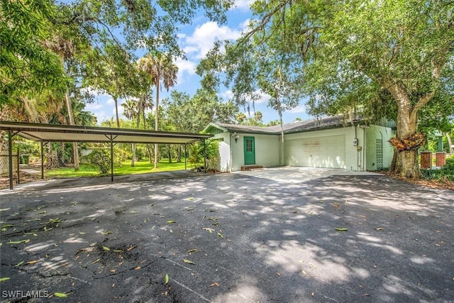 view of front facade with a carport and a garage