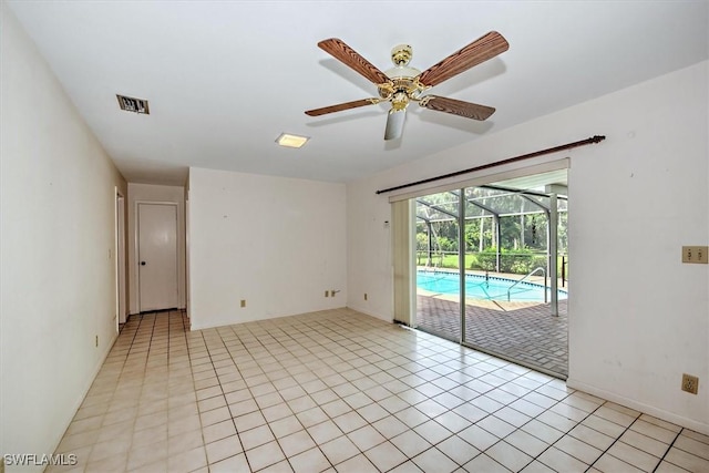 spare room featuring light tile patterned floors and ceiling fan