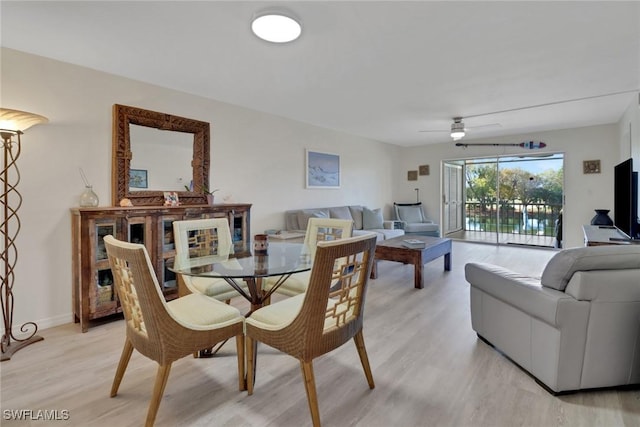 dining area featuring ceiling fan and light wood-type flooring