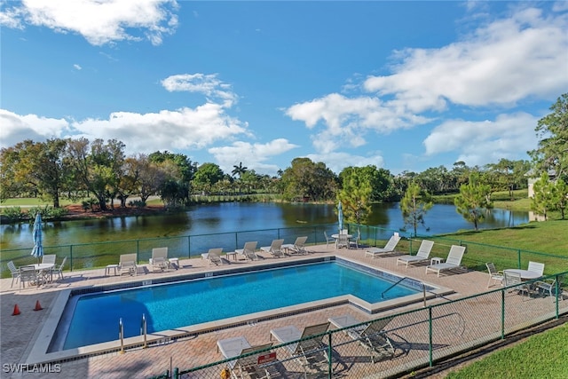 view of swimming pool featuring a patio area and a water view