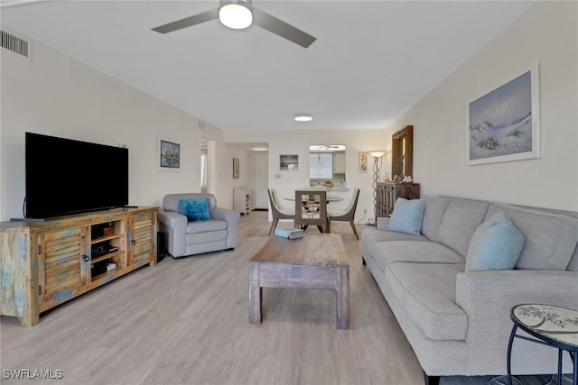 living room with ceiling fan and light wood-type flooring