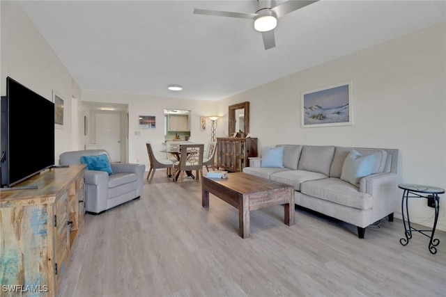 living room with ceiling fan and light hardwood / wood-style floors