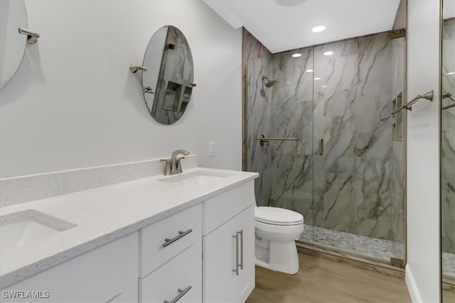 full bathroom with a sink, toilet, a marble finish shower, recessed lighting, and wood finished floors
