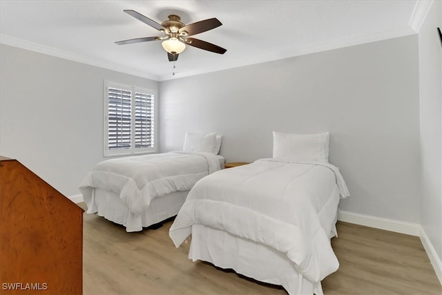 bedroom featuring ceiling fan, light hardwood / wood-style floors, and ornamental molding