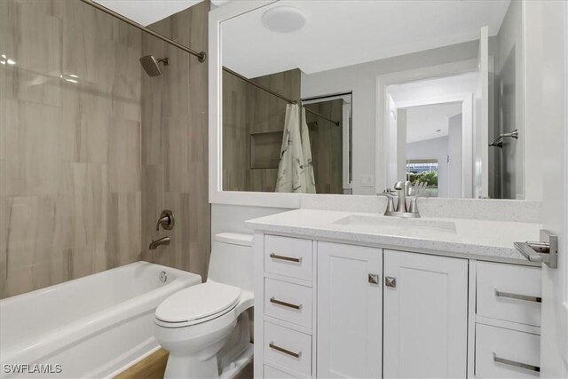 full bathroom featuring vanity, shower / bath combo, and toilet