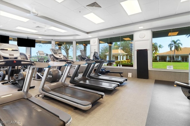 workout area featuring a paneled ceiling and ceiling fan