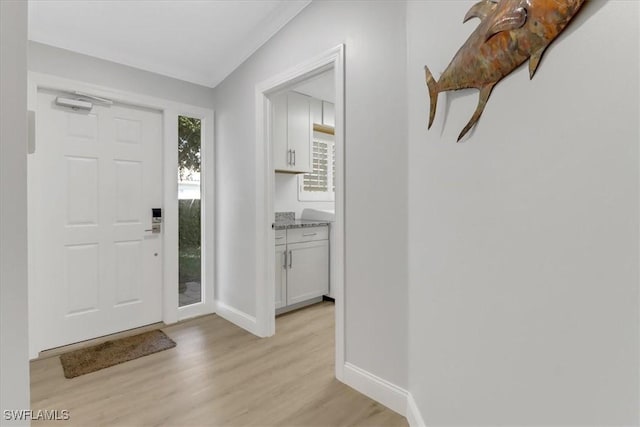 entrance foyer with light wood-type flooring and baseboards