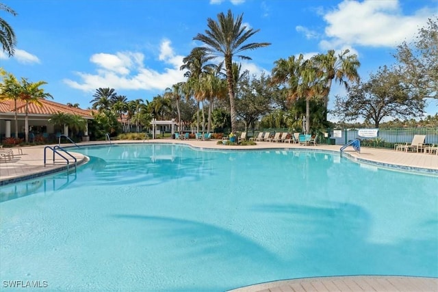 pool featuring fence and a patio
