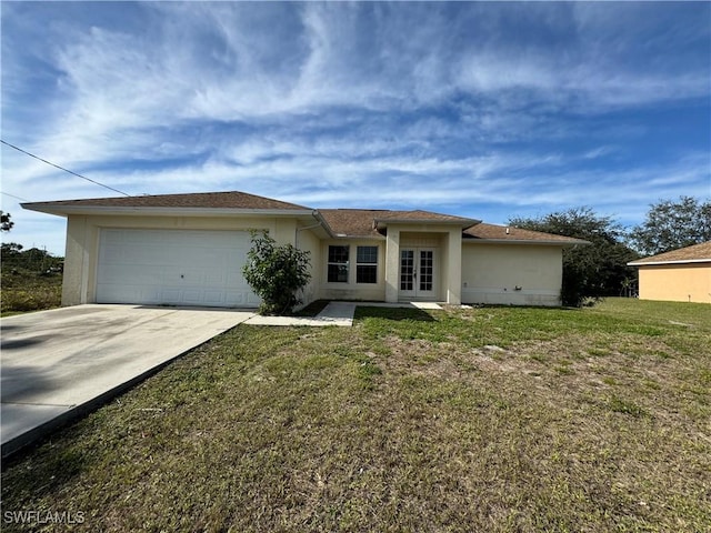 single story home featuring french doors, a front lawn, and a garage