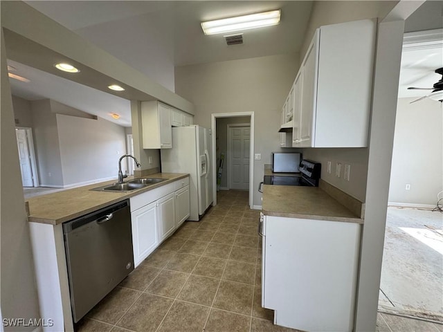 kitchen with dishwasher, white cabinets, vaulted ceiling, and sink