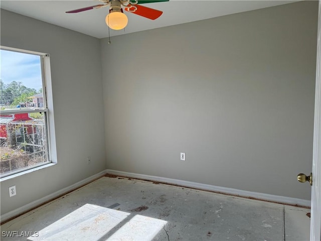 empty room featuring ceiling fan and plenty of natural light