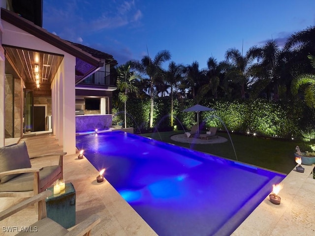 pool at dusk with pool water feature