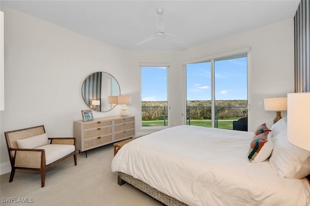 bedroom with ceiling fan, light carpet, and access to outside