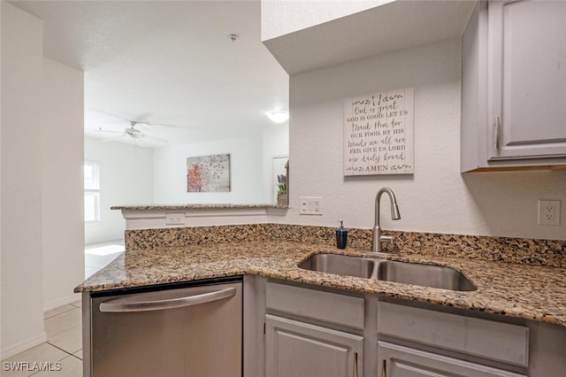 kitchen featuring ceiling fan, sink, stainless steel dishwasher, stone countertops, and gray cabinets