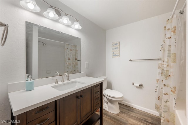 bathroom featuring hardwood / wood-style floors, vanity, and toilet