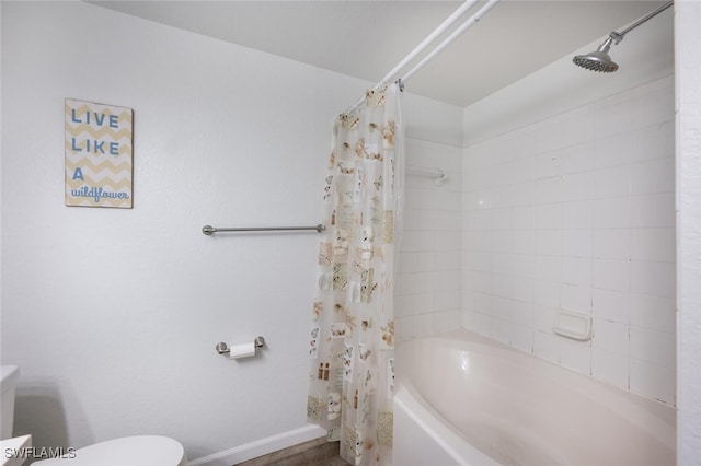 bathroom featuring shower / tub combo with curtain and toilet