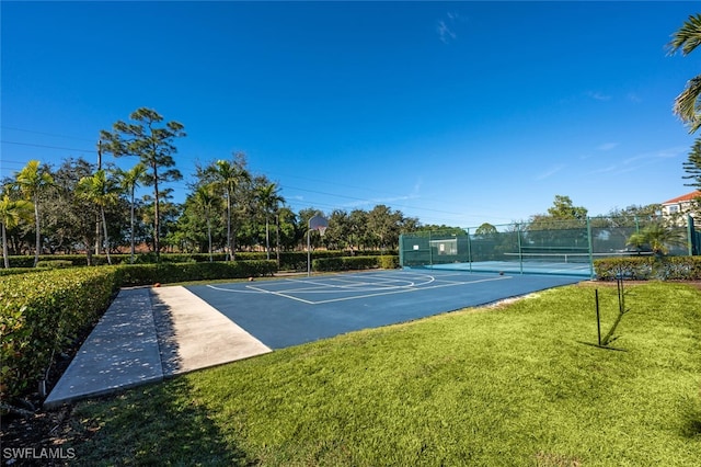 view of sport court with a lawn and tennis court