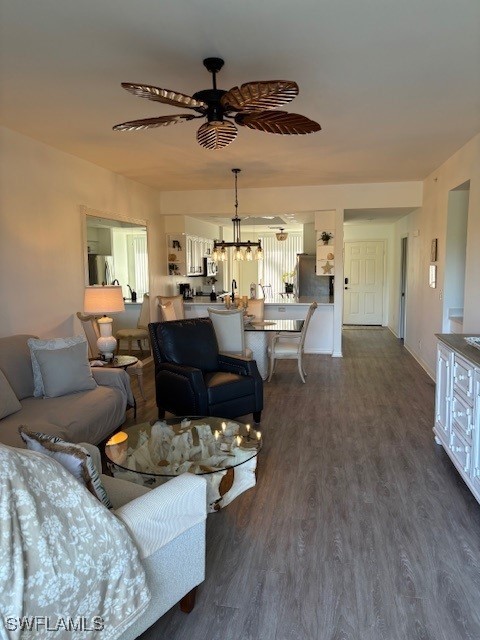 living room featuring ceiling fan and dark wood-type flooring